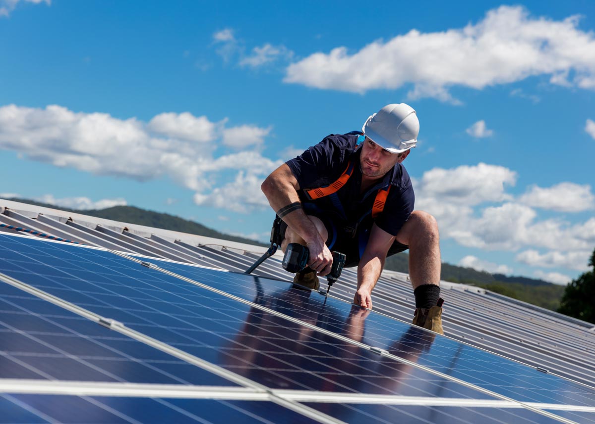 solar panel installer on the roof